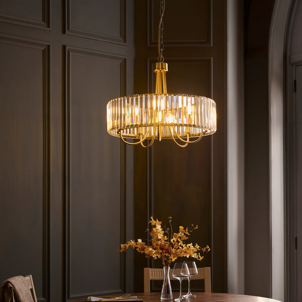 Visconti 5 Light Chandelier in antique brass hanging in a dining room