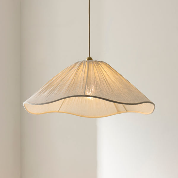 Isabella Pendant lit up in a styled bedroom