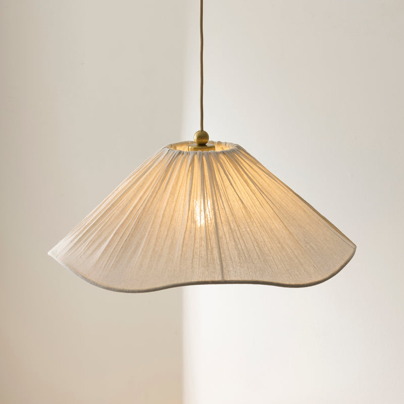 Isabella Pendant in brushed aged brass shown in a room setting