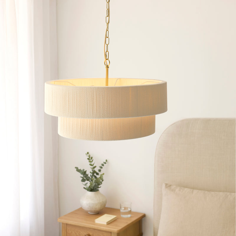 Noah 5 Light Tiered Pendant lit up in a styled living room