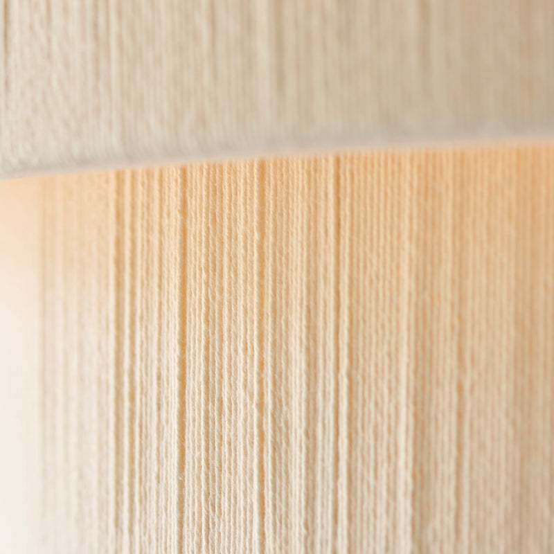 Detail of the brushed brass and cream cotton finish on the Noah 5 Light Tiered Pendant