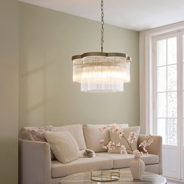 Lucille 5 Light Chandelier in antique brass hanging in a living room