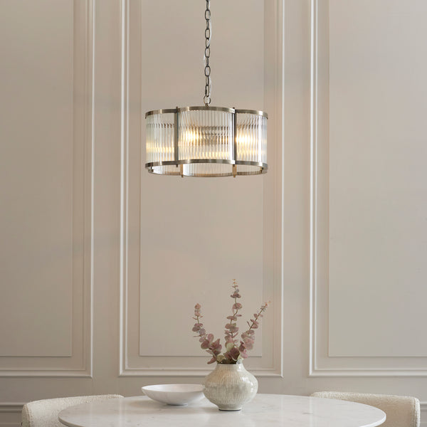 Ridgeton Scallop 3 Light Pendant in antique brass hanging in a hallway