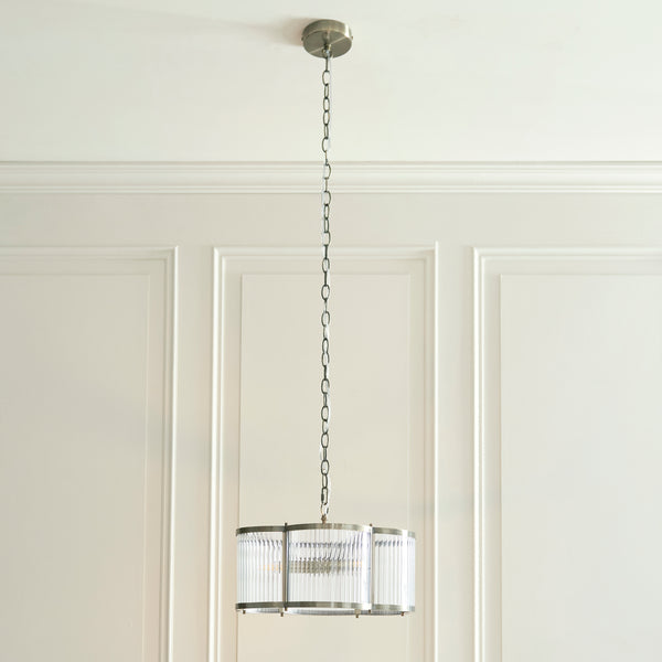 Ridgeton Scallop 3 Light Pendant lit up in a styled hallway