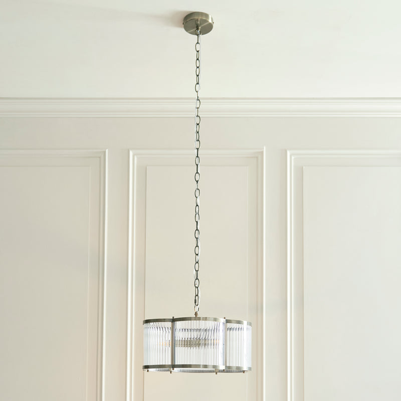 Ridgeton Scallop 3 Light Pendant lit up in a styled hallway