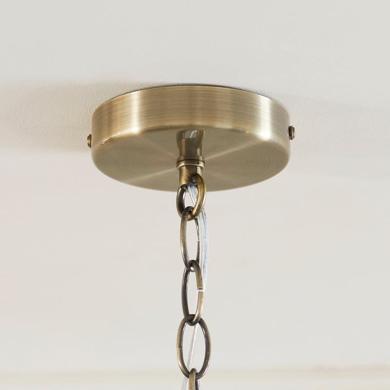 Detail of the antique brass finish on the Ridgeton Scallop 3 Light Pendant