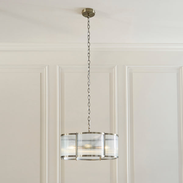 Ridgeton Scallop 5 Light Pendant lit up in a styled living room
