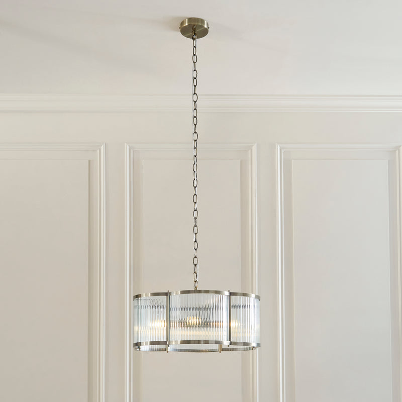 Ridgeton Scallop 5 Light Pendant lit up in a styled living room