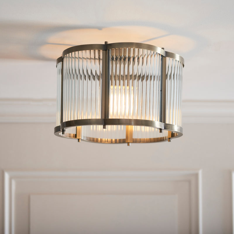 Ridgeton Scallop Flush Ceiling Light lit up in a styled hallway