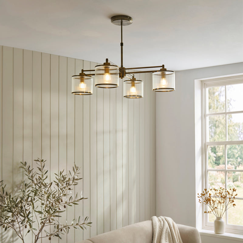 Ridgeton 4 Light Pendant in antique brass hanging in a dining room