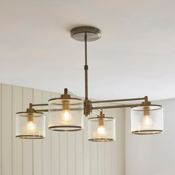 Ridgeton 4 Light Pendant lit up in a styled dining room