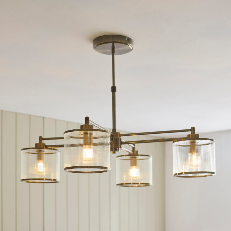 Ridgeton 4 Light Pendant lit up in a styled dining room
