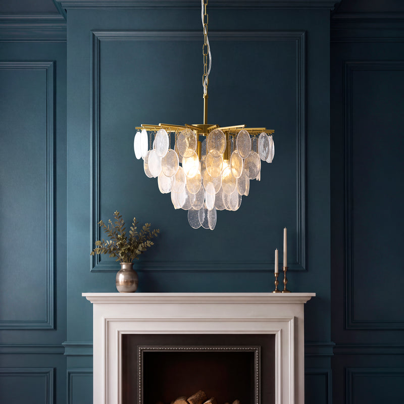 Loretta 3 Light Pendant in brushed aged brass hanging in a dining room