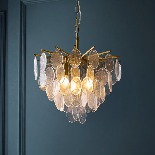 Loretta 3 Light Pendant lit up in a styled dining room
