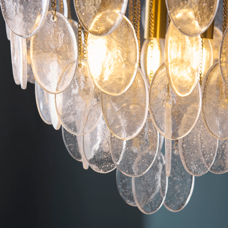 Detail of the brushed aged brass finish on the Loretta 3 Light Pendant