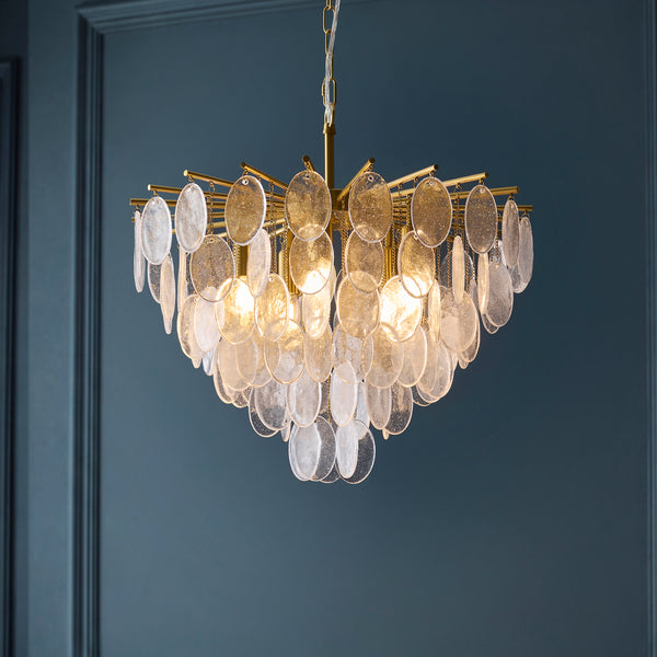 Loretta 5 Light Pendant lit up in a styled dining room