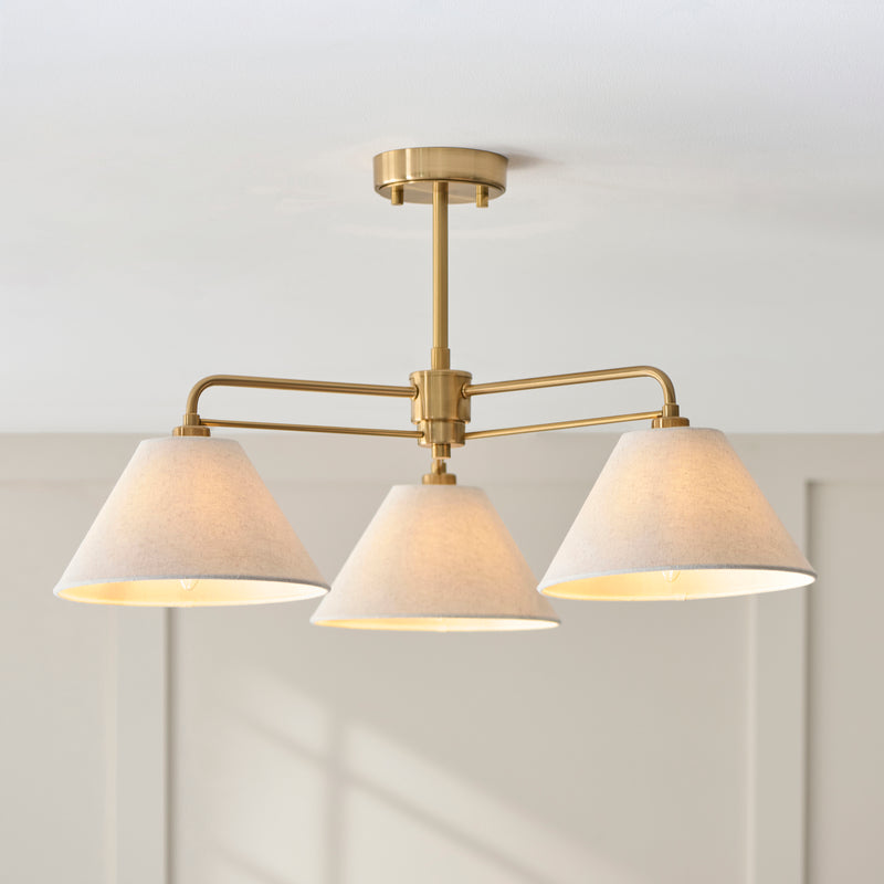 Wallbridge 3 Light Semi Flush Ceiling Light in brushed aged brass shown in a room setting