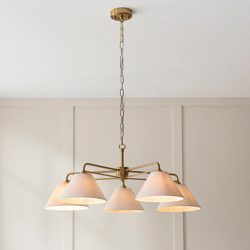 Wallbridge 5 Light Chandelier lit up in a styled living room
