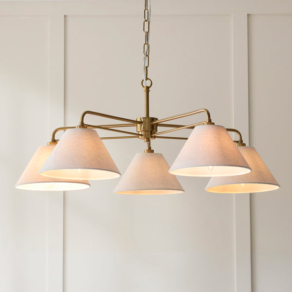 Wallbridge 5 Light Chandelier in brushed aged brass shown in a room setting