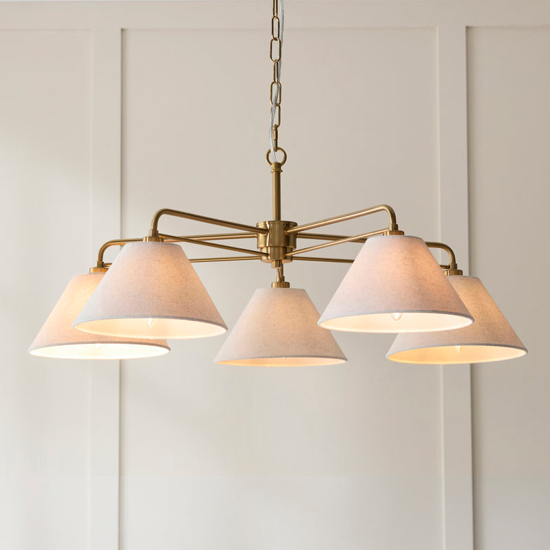 Wallbridge 5 Light Chandelier in brushed aged brass shown in a room setting