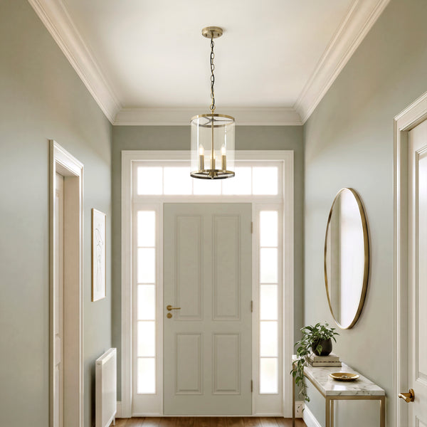 Hebden 3 Light Pendant in antique brass hanging in a hallway