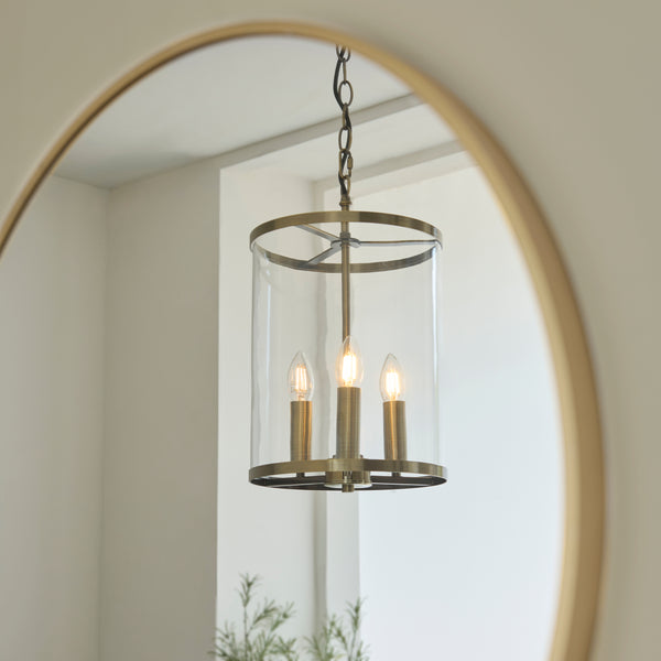 Hebden 3 Light Pendant in antique brass shown in a room setting