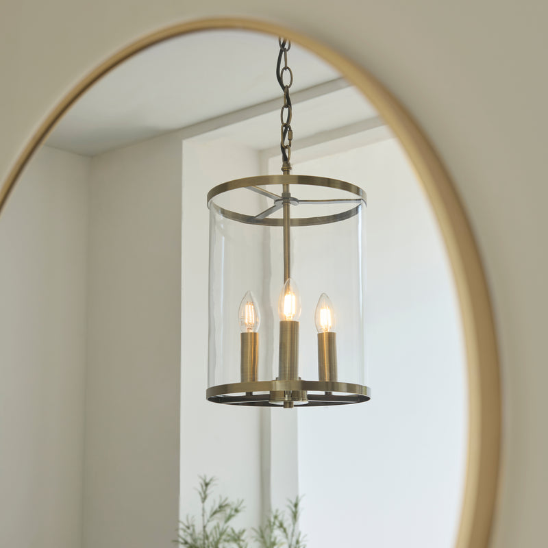 Hebden 3 Light Pendant in antique brass shown in a room setting