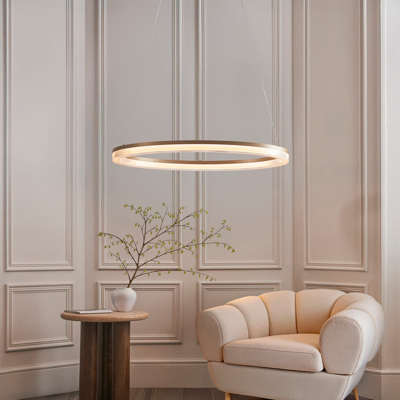 Lansina LED Hoop Pendant in brushed gold hanging in a living room