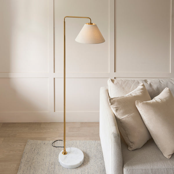 Wallbridge Floor Lamp lit up in a living room setting