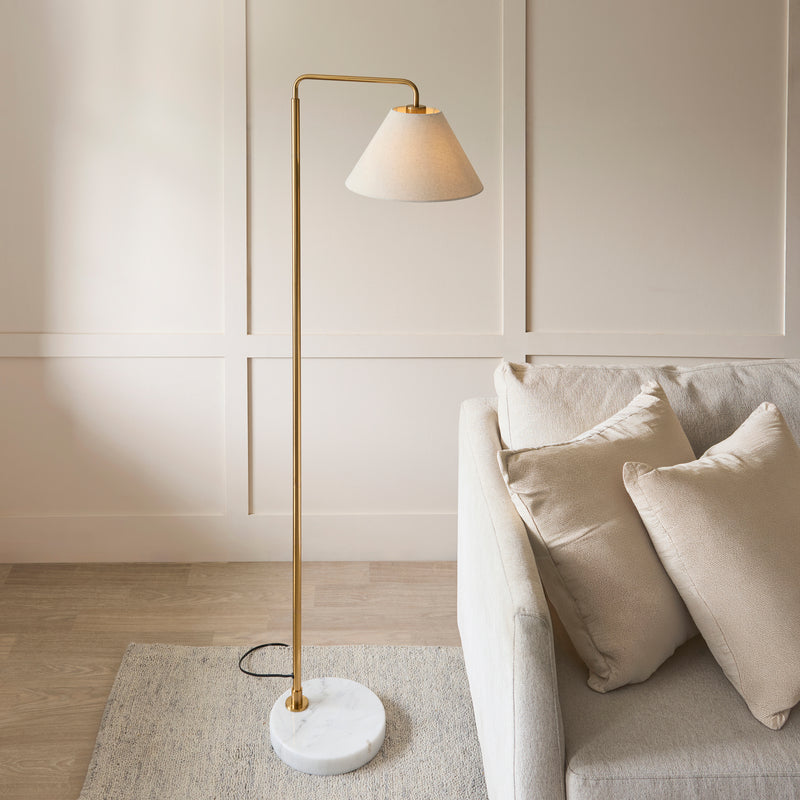Wallbridge Floor Lamp lit up in a living room setting