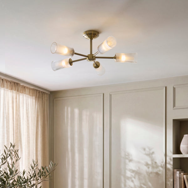 Avelyn 5 Light Semi Flush Ceiling Light in antique brass on a living room ceiling
