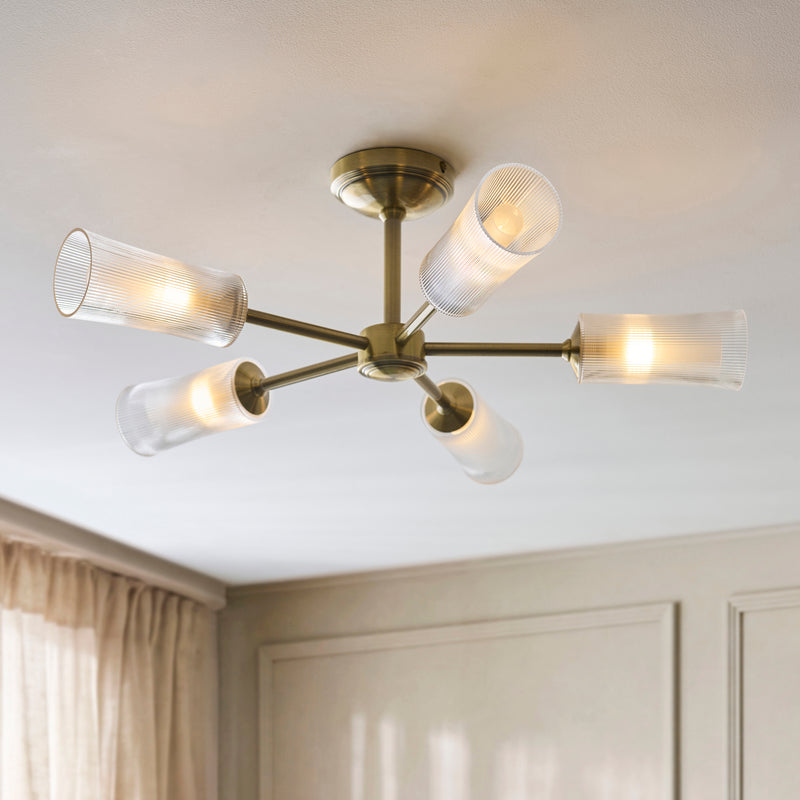 Avelyn 5 Light Semi Flush Ceiling Light lit up in a styled living room