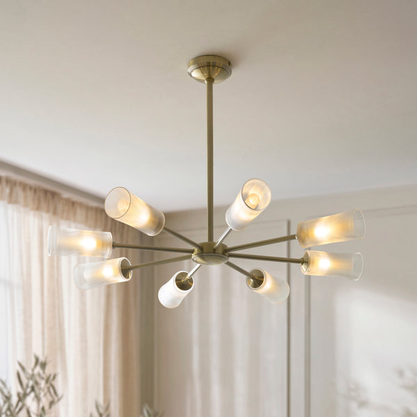 Avelyn 8 Light Chandelier lit up in a styled living room