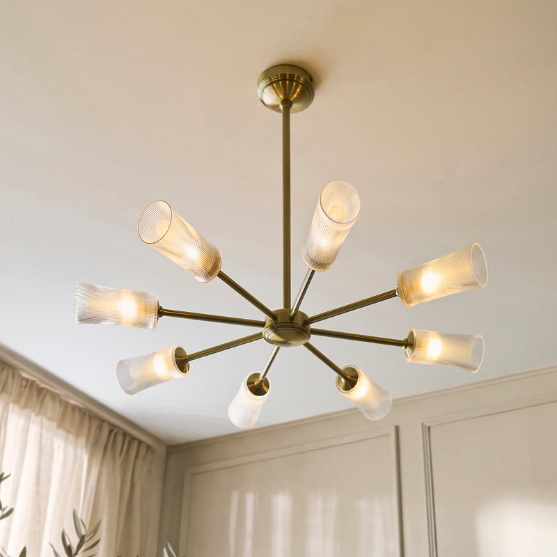 Avelyn 8 Light Chandelier in antique brass shown in a room setting