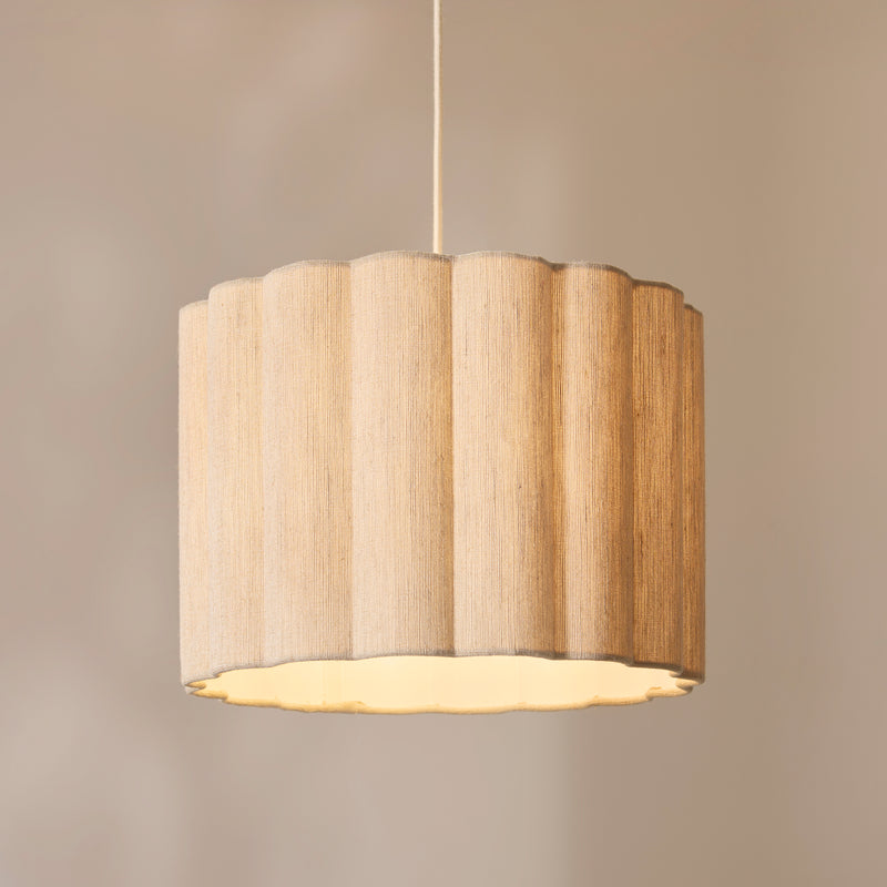Olson Pendant lit up in a styled bedroom