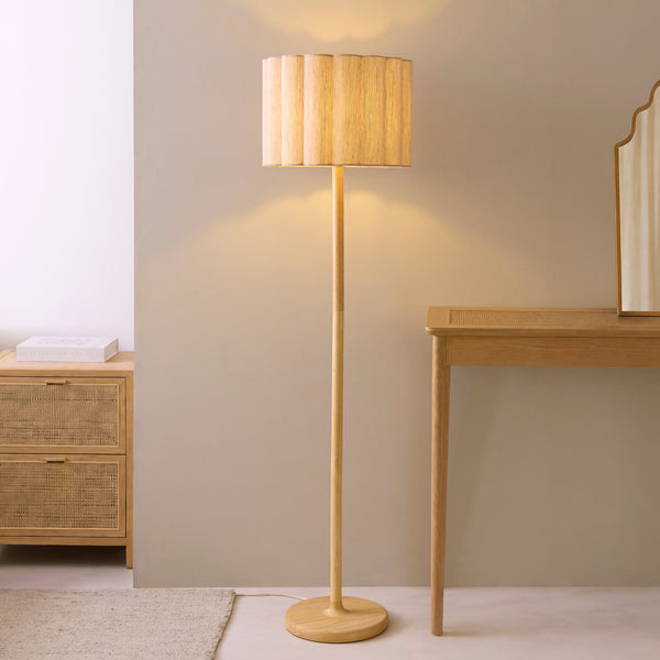 Olson Floor Lamp lit up in a bedroom setting