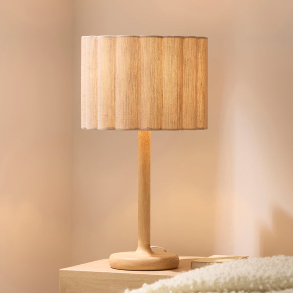 Olson Table Lamp lit up in a bedroom setting
