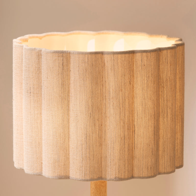 Olson Table Lamp lit up in a bedroom setting