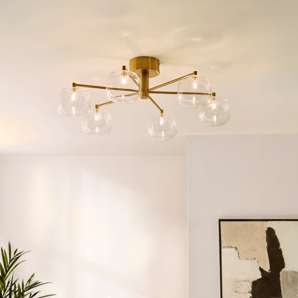 Oslo 6 Light Semi Flush Ceiling Light in brushed aged brass on a living room ceiling
