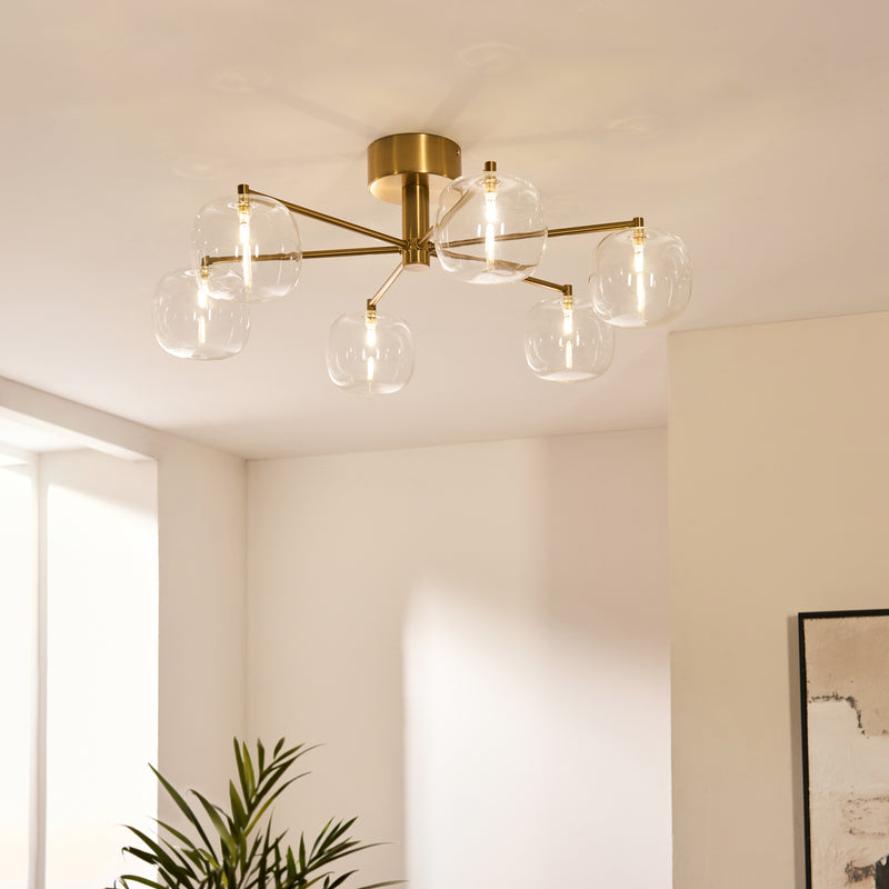 Oslo 6 Light Semi Flush Ceiling Light lit up in a styled living room