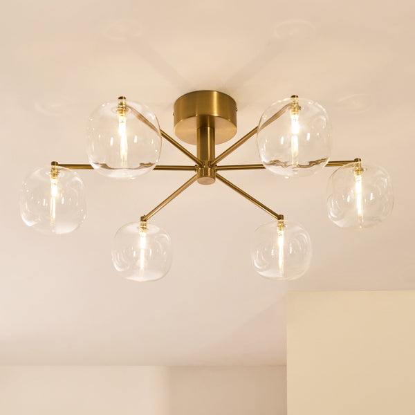 Oslo 6 Light Semi Flush Ceiling Light in brushed aged brass shown in a room setting
