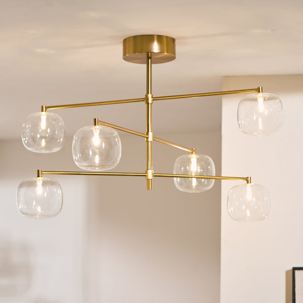 Oslo 6 Light Linear Pendant lit up in a styled dining room