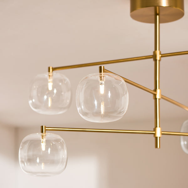 Oslo 6 Light Linear Pendant in brushed aged brass shown in a room setting