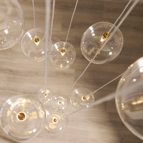 Oslo 12 Light Cascade Pendant in brushed aged brass shown in a room setting