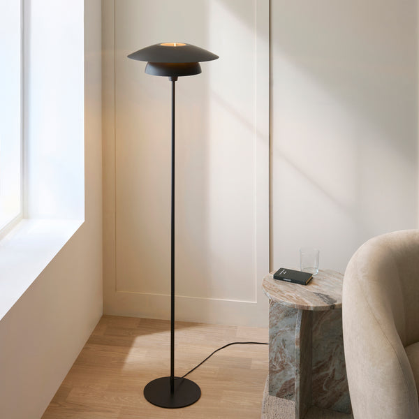 Lyon Floor Lamp lit up in a living room setting