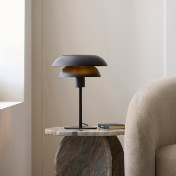 Lyon Table Lamp lit up in a bedroom setting