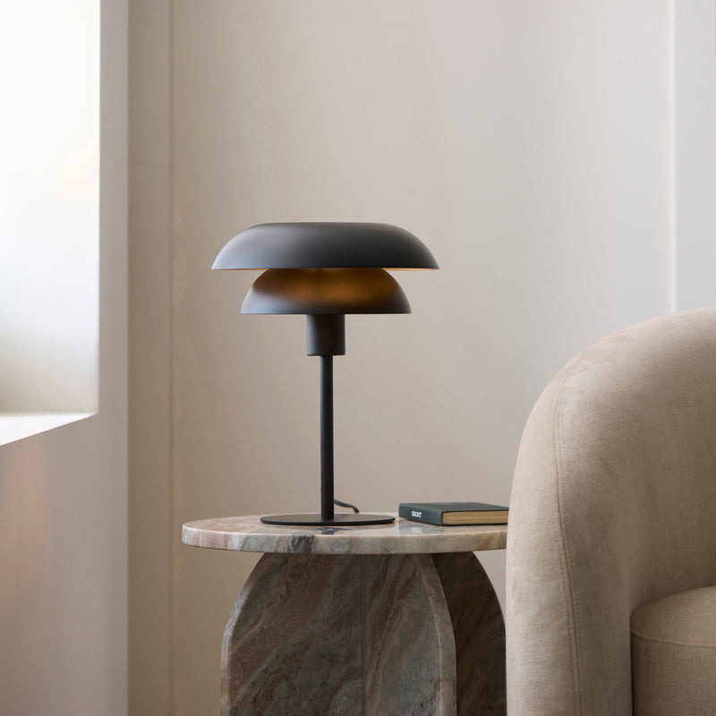 Lyon Table Lamp lit up in a bedroom setting