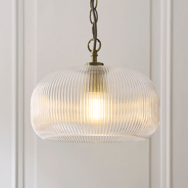 Harborne Pendant in antique brass shown in a room setting