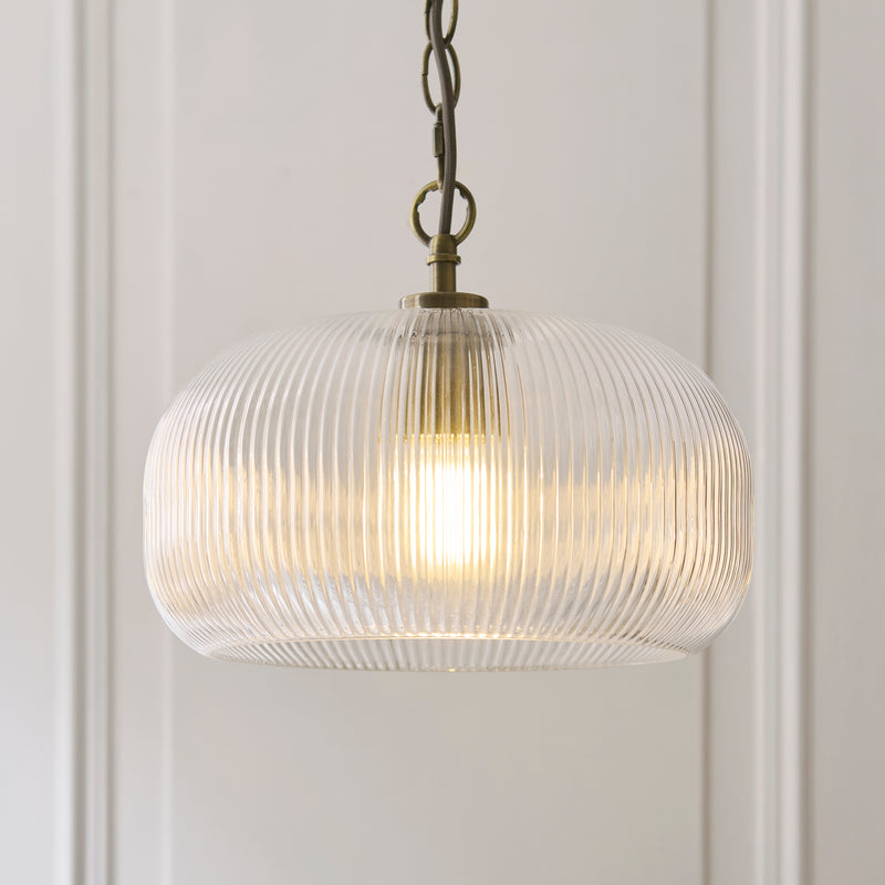 Harborne Pendant in antique brass shown in a room setting