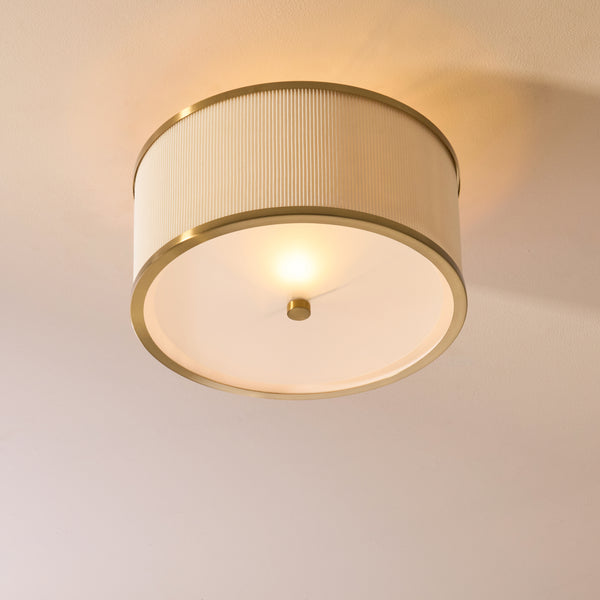 Lexi Flush Ceiling Light lit up in a styled bedroom